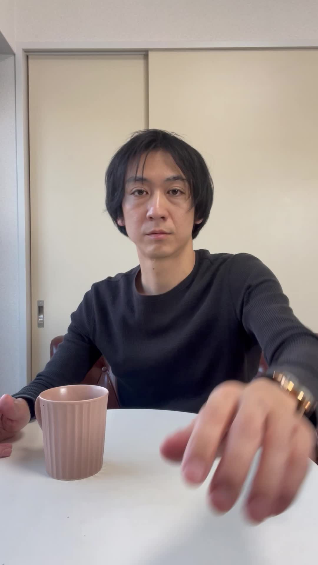 テーブルで飲み物を前に、「これが腸に良いのかな？」と少し戸惑う様子
