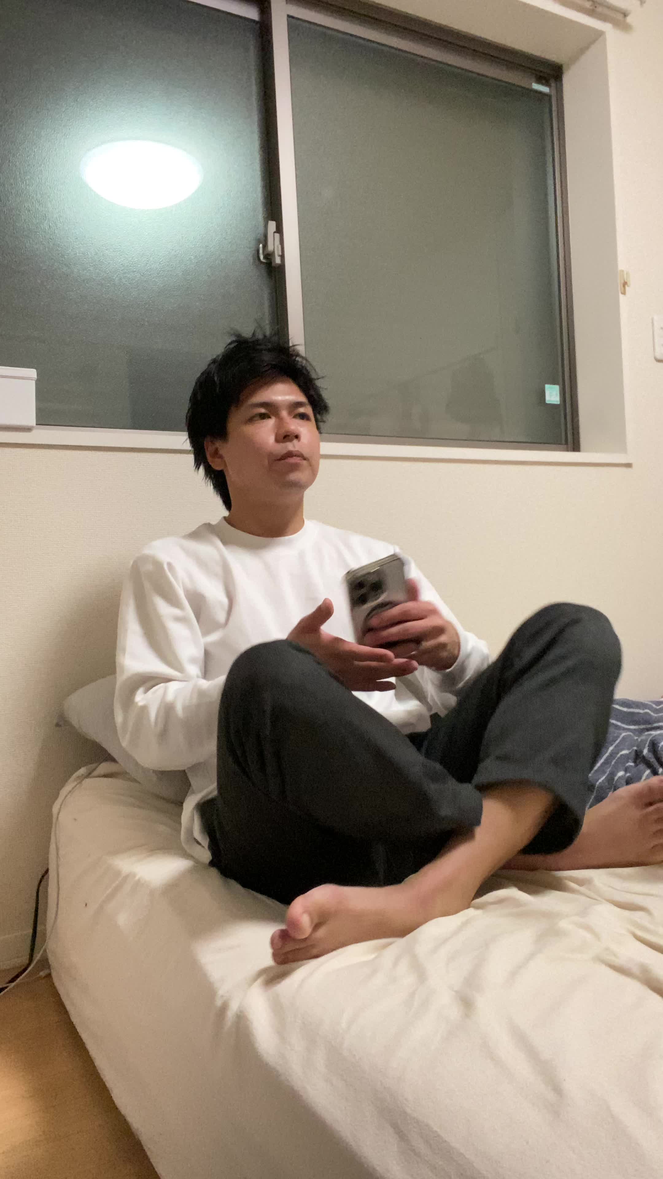 ベッドで横になりながら、「新しい自分に期待して胸を膨らませる」リラックスした笑顔