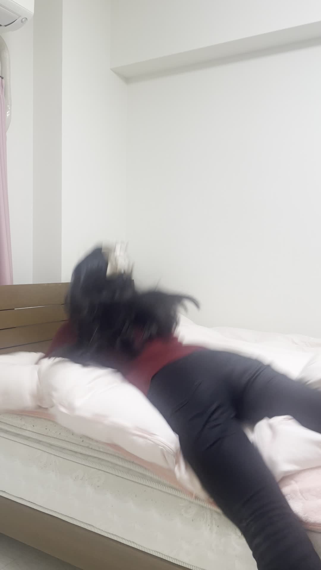 ベッドに倒れ込む後ろ姿