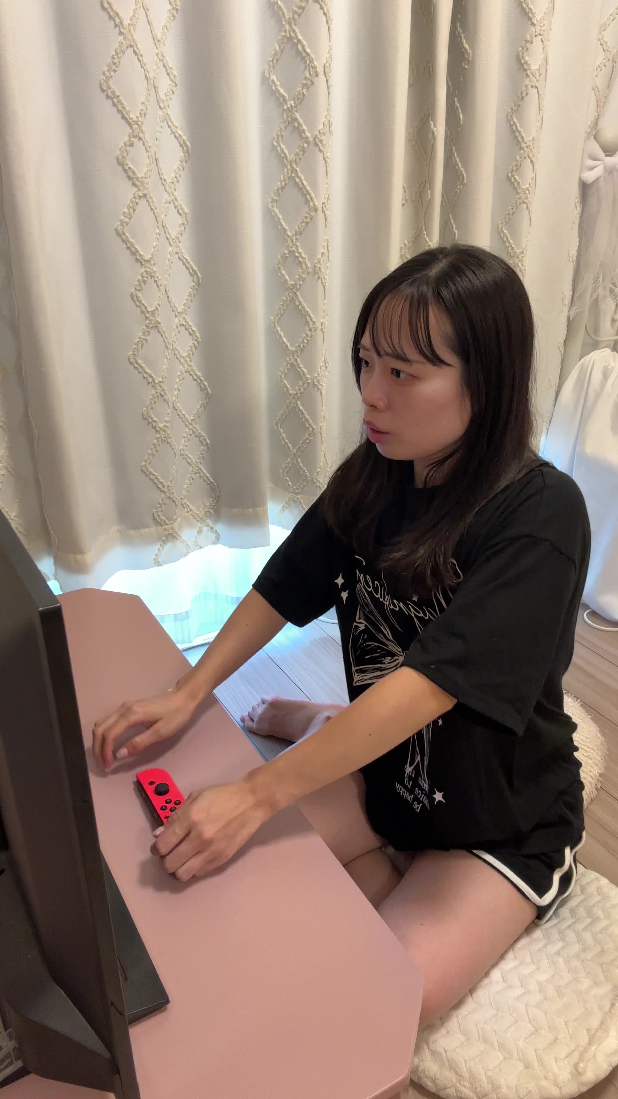 椅子に座り直し、コントローラーを置いて「次の戦略を考える」集中した表情
