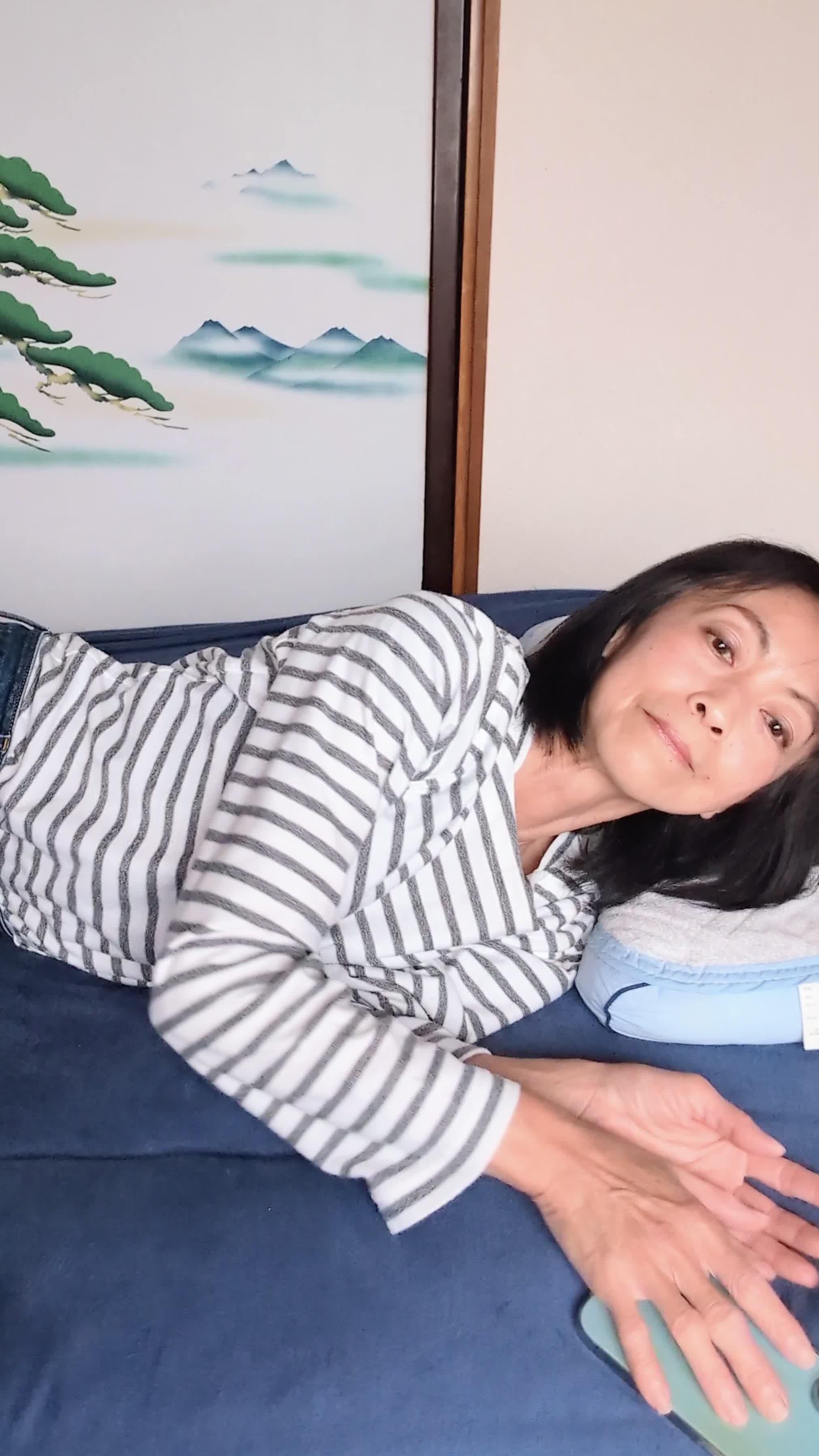 ベッドで横になり、「このシリーズ、最終話まで一気に観ちゃった！」と達成感のある笑顔