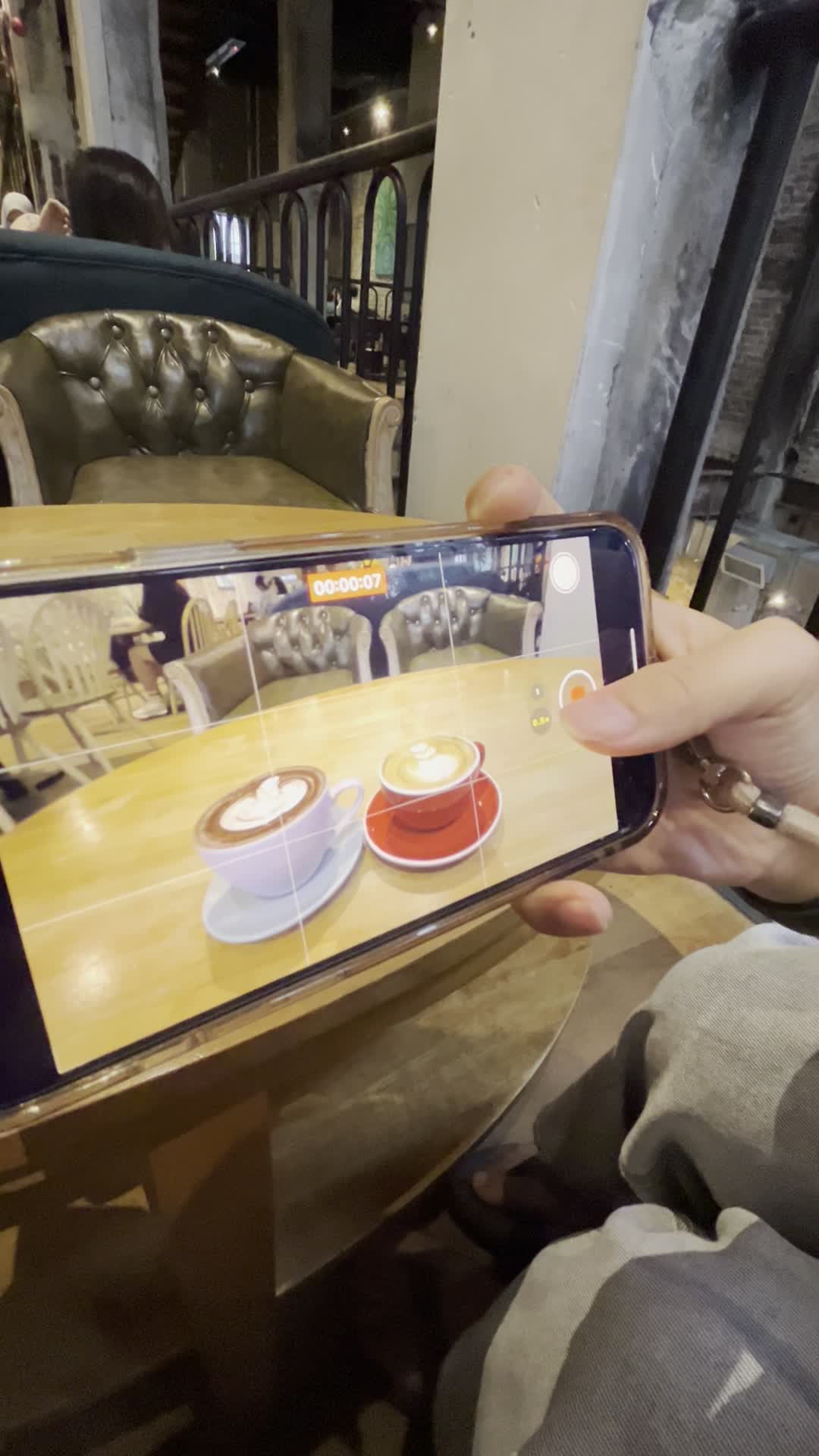 机にある飲み物を撮影する様子