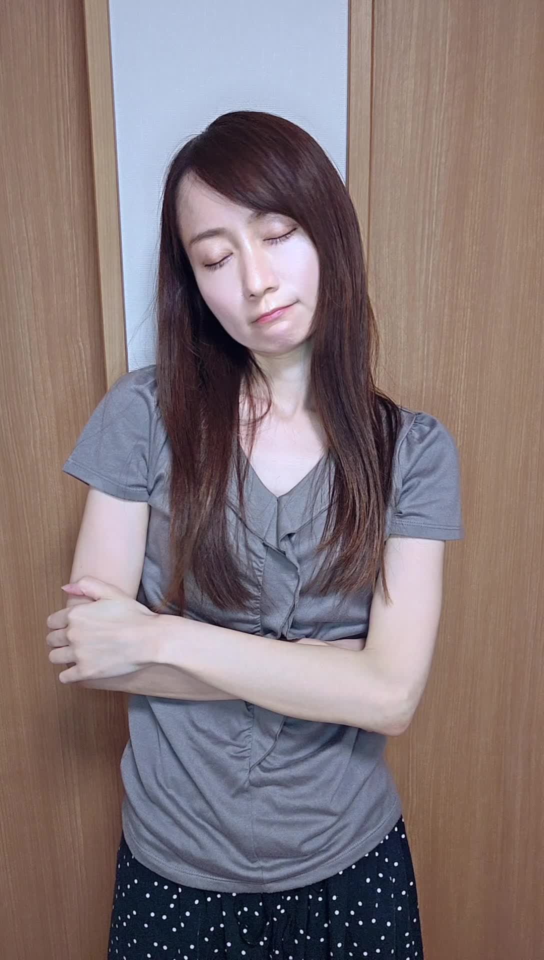 壁に背を預けて静かに目を閉じ、悩みを抱えている仕草をする