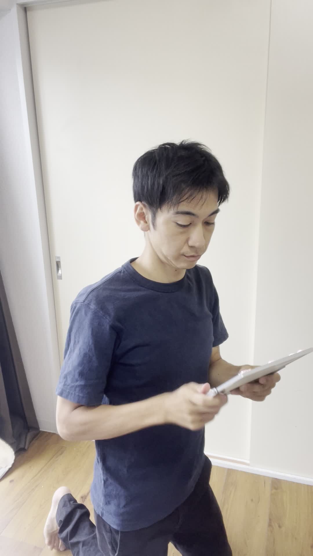 床に膝をつき、鏡を持って頭頂部を確認する仕草をする