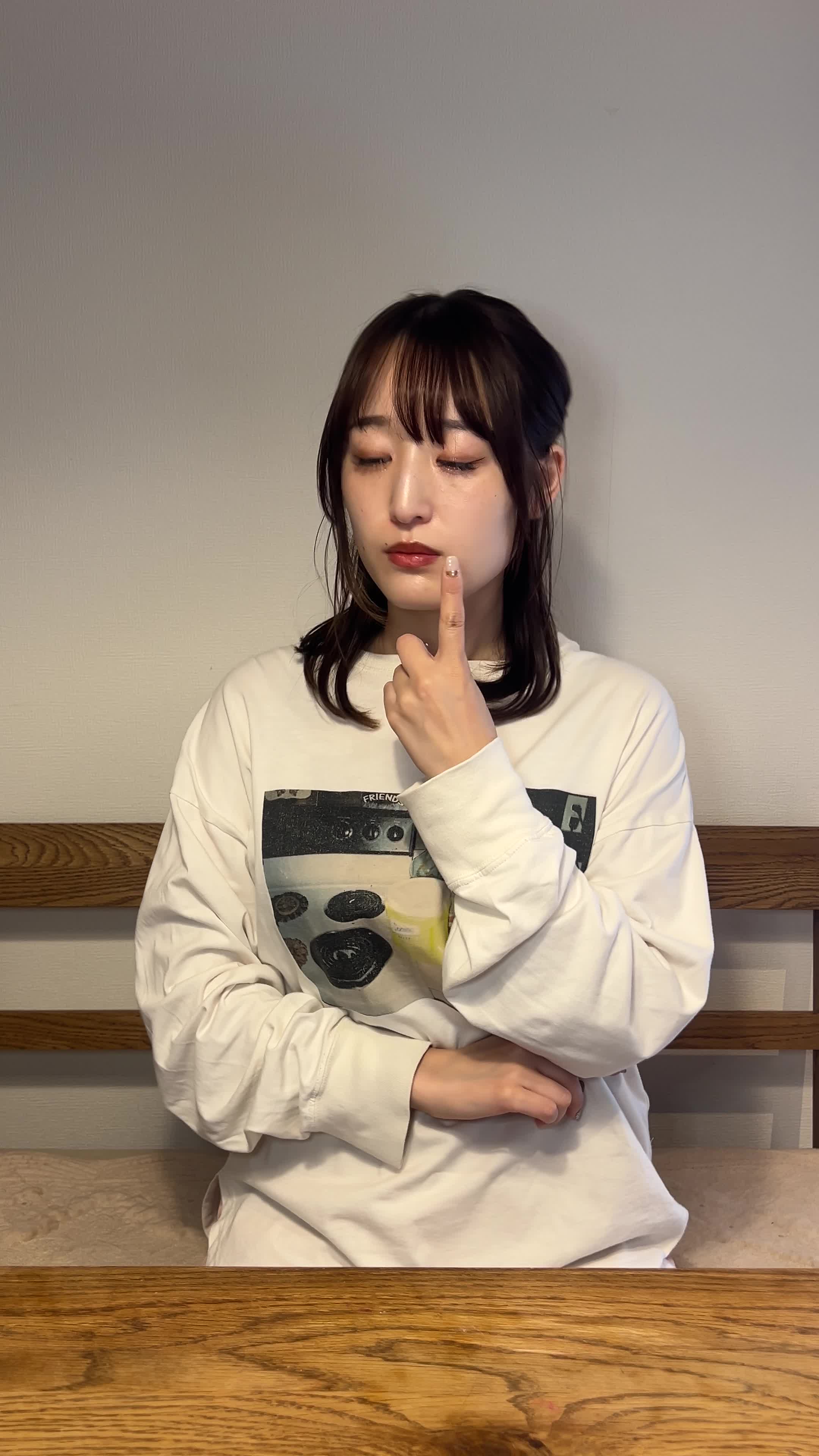 指先で唇を軽く触りながら肌の状態を気にしている仕草をする