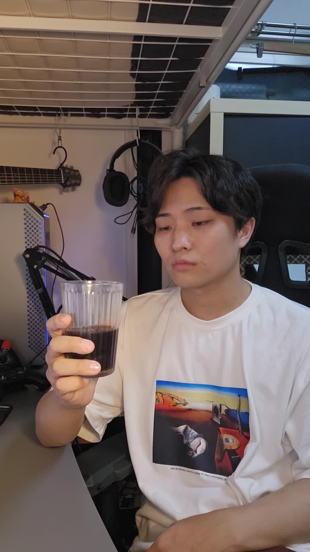 テーブルでカップを手に取り、「腸の不調がこんなに続くとは…」と困った顔をする様子