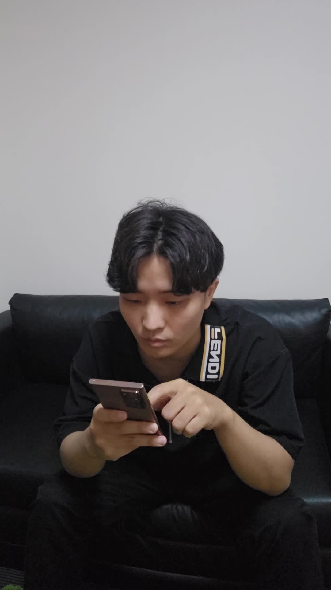 ソファでスマホを眺めながら、「健康ドリンクの口コミを見て少し希望を感じる」表情