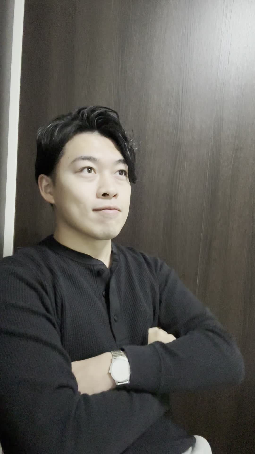 椅子に深く座り、「これで自信を取り戻せる」と軽く頷きながら微笑む表情