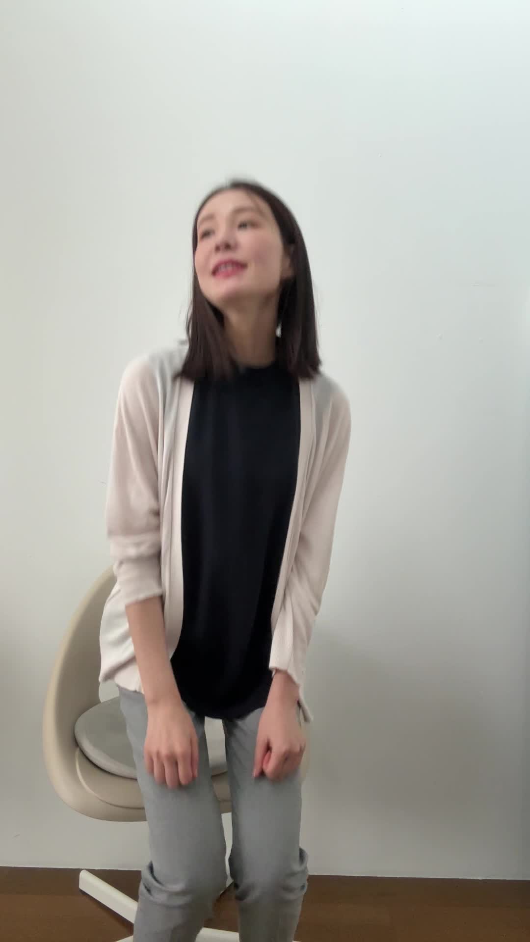 椅子から立ち上がり、「これで備えは万全」と自信を持つ笑顔を見せる動作