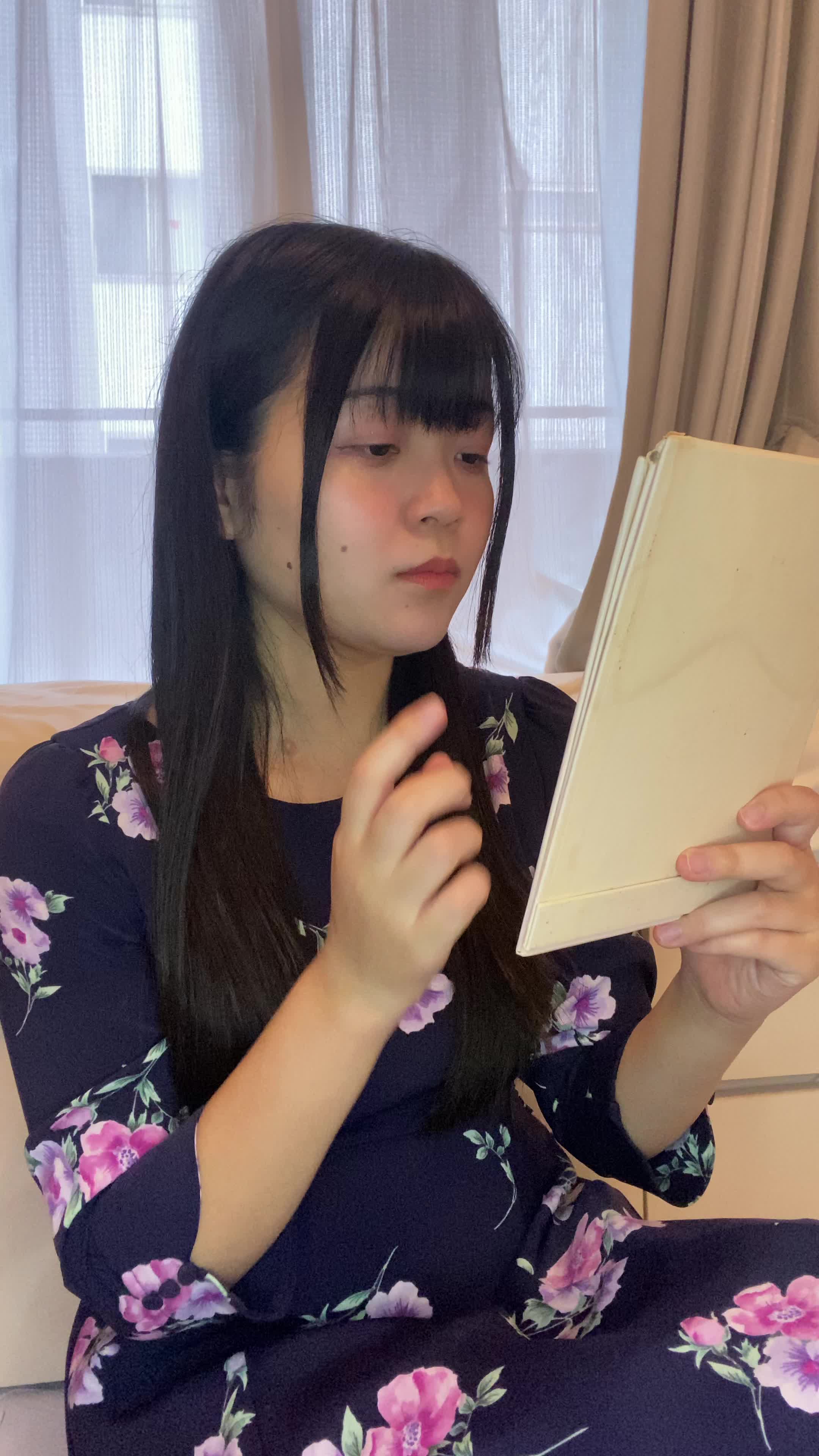 床に座り込み、手鏡で自分の歯をじっくり観察し、「これが変わるかな？」と期待する表情