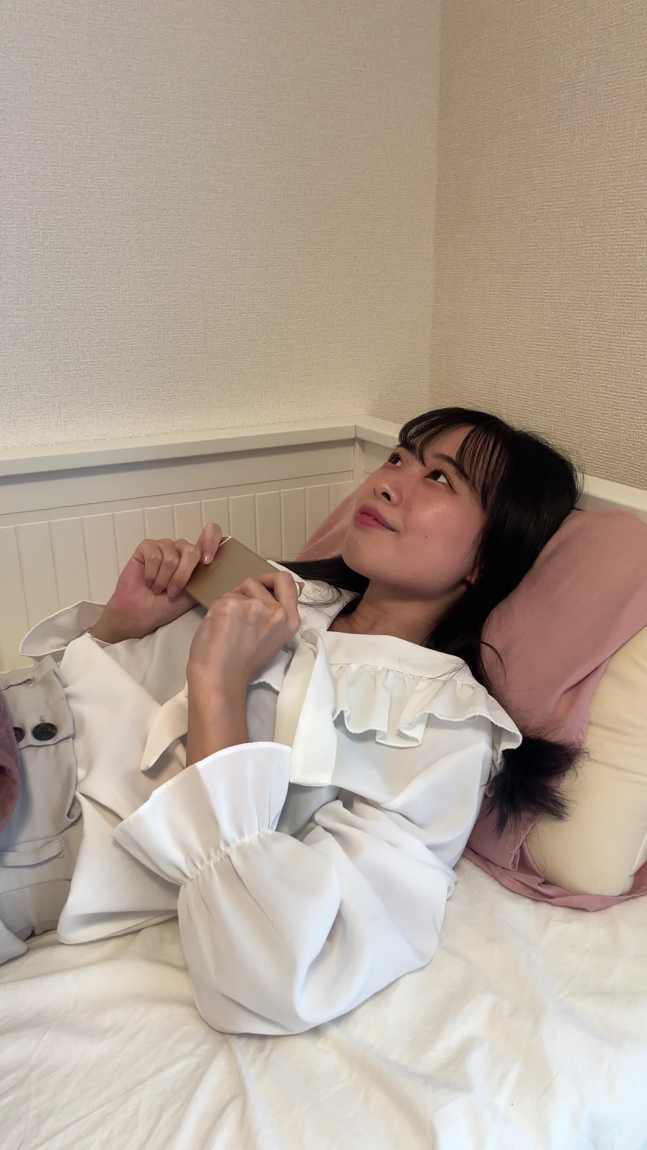 ベッドで横になり、「このシリーズ、最終話まで一気に観ちゃった！」と達成感のある笑顔