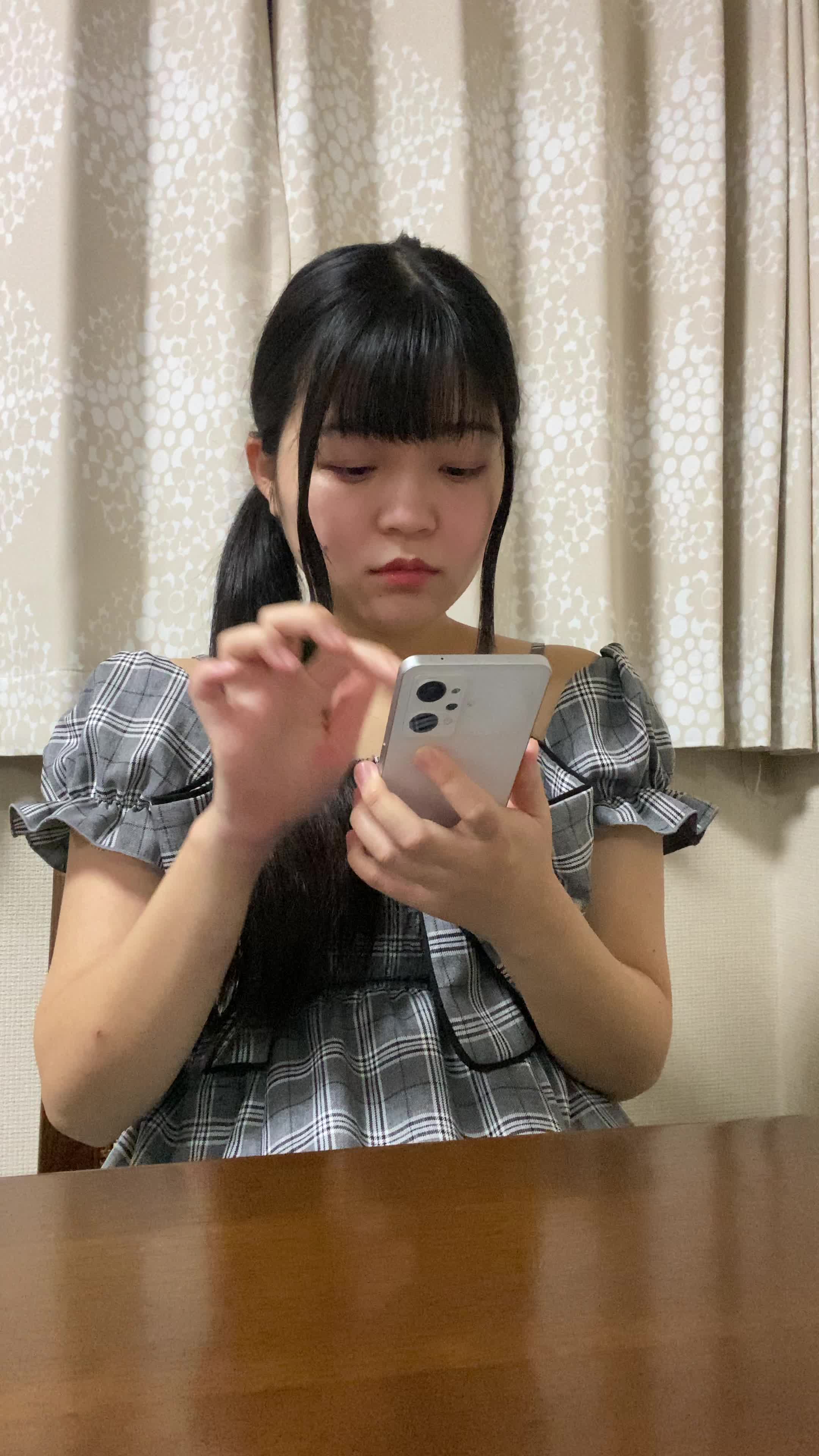 テーブルでスマホを操作しながら、「レビューを読んで納得する」真剣な表情