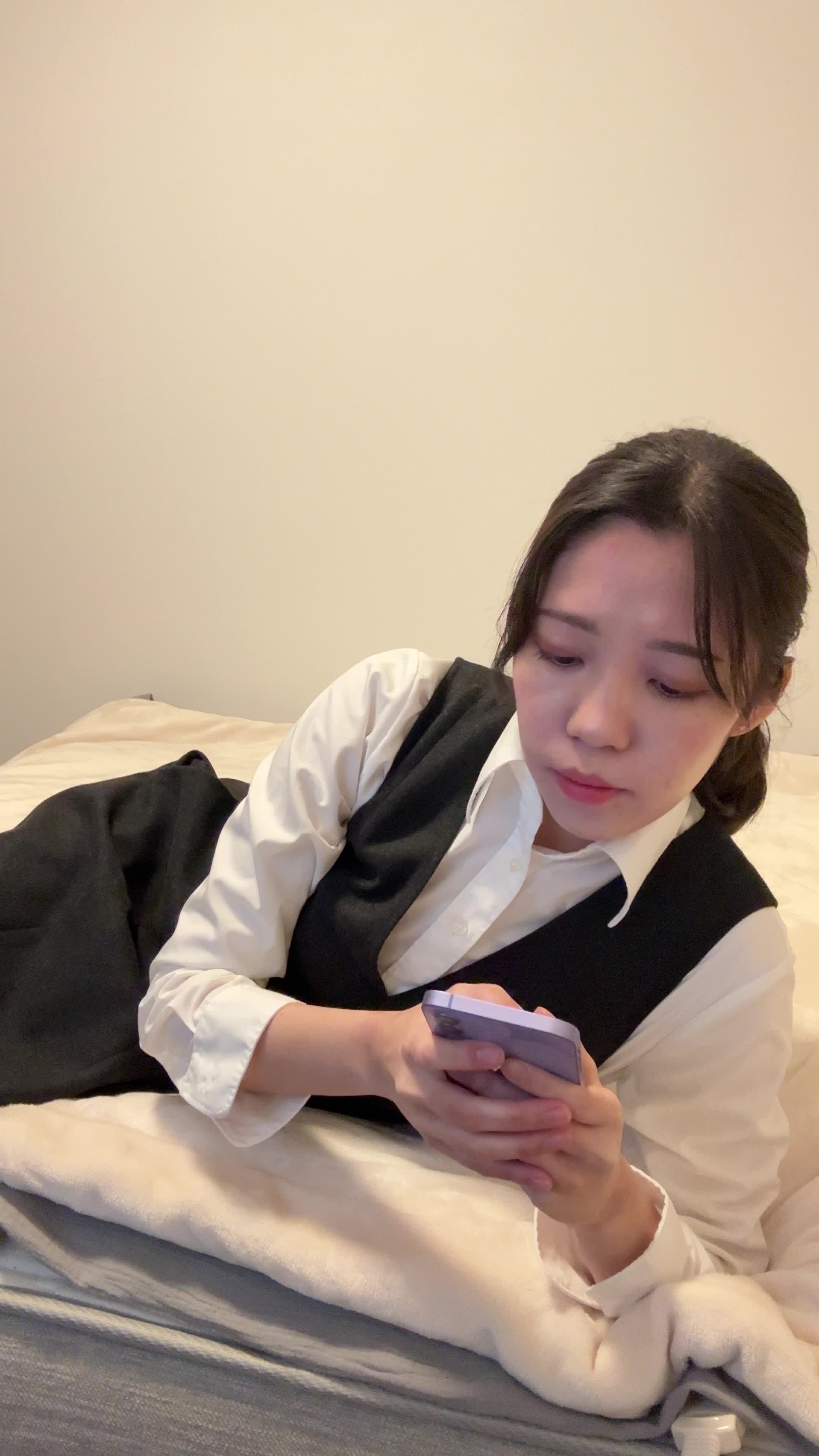 ベッドで脚を伸ばし、スマホの画面を見ながら「契約前にチェックするポイント」を確認する表情