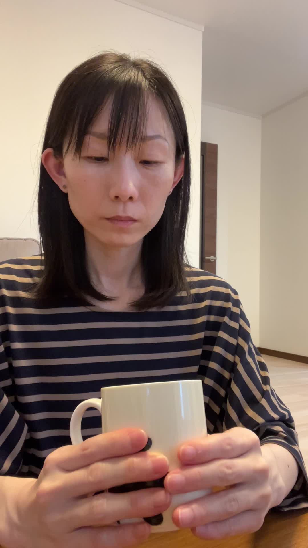 テーブルで飲み物を前に置き、「これが体に効けば嬉しい」と試す前の期待の様子