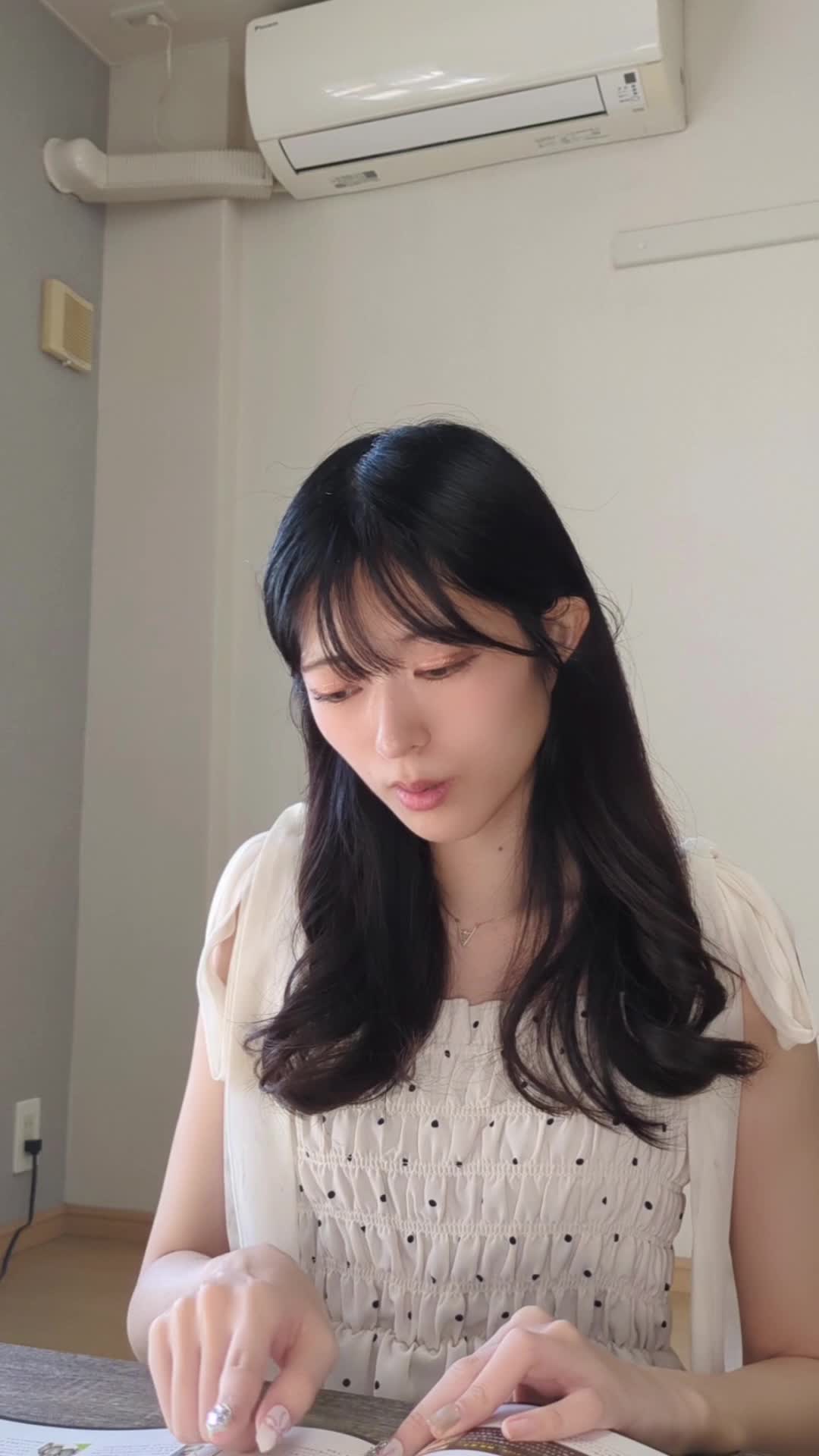 テーブルで脱毛のプラン表を広げ、「これなら私でも行けそう！」と笑顔を浮かべる顔